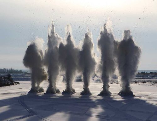 Военные саперы взрывают лед на реке Енисей  